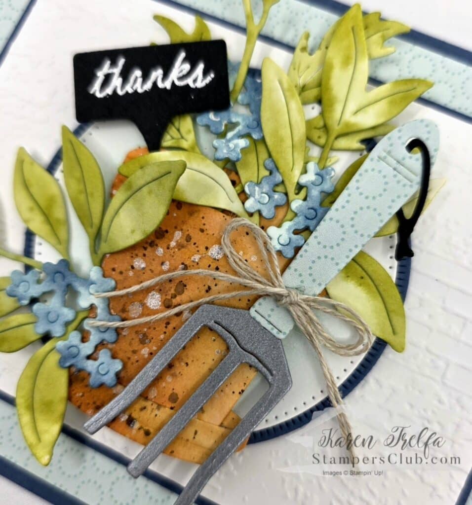 Close up of watercolored terracotta pot with ink spattering on handmade garden card
