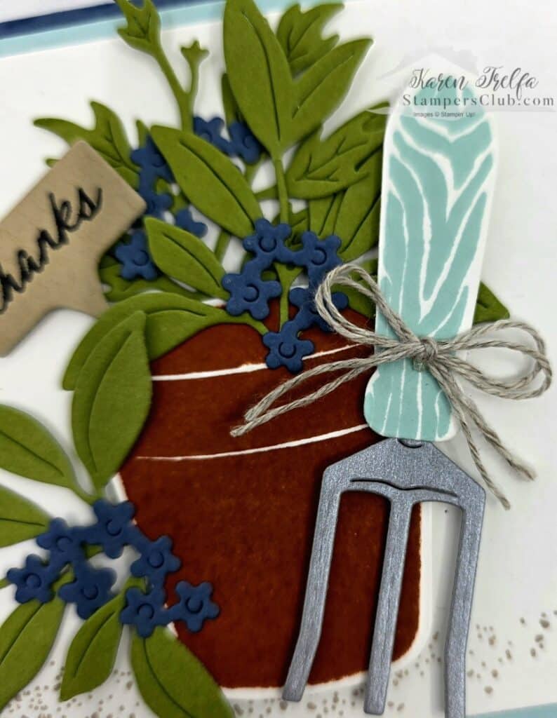 Close up detail of simple garden card with garden rake and thanks pick