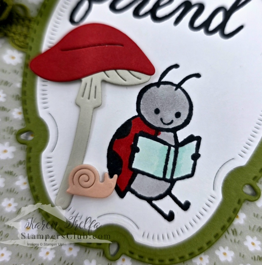 Close-up of a hand-colored ladybug reading a book beneath a red mushroom die cut with a snail detail from a Sweet Bugs Stampin' Up card
