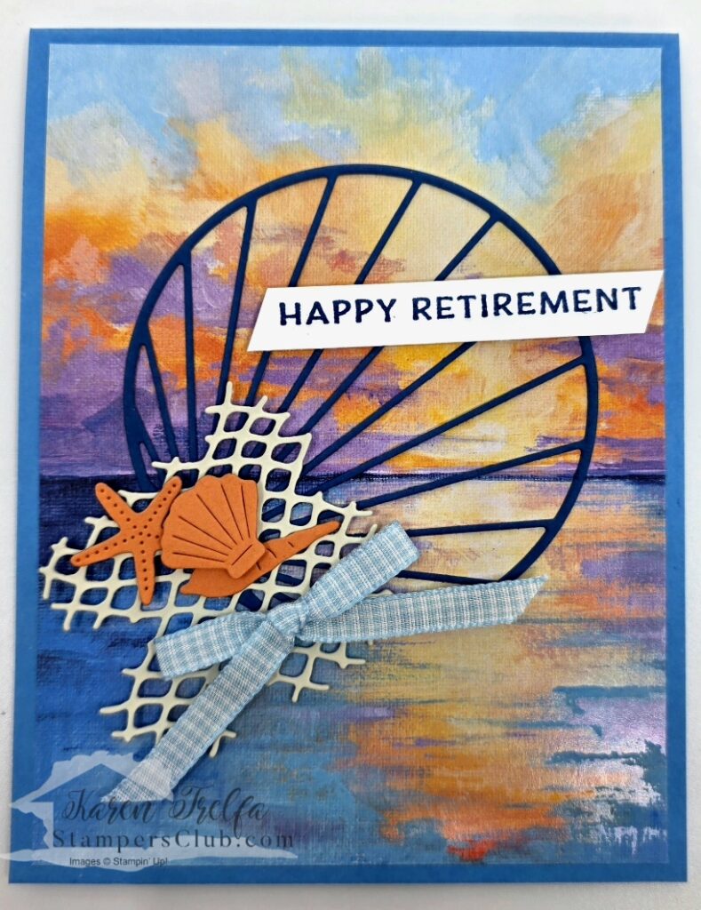 scenic-coast-happy-retirement-card Scenic Coast Stampin' Up Happy Retirement card with a large Secret Sea shell die cut over a painted sunset designer paper background with netting, starfish, and seashell embellishments and Balmy Blue Gingham ribbon